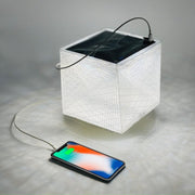 MEGAPUFF solar lantern charging iPhone with panel facing sunlight